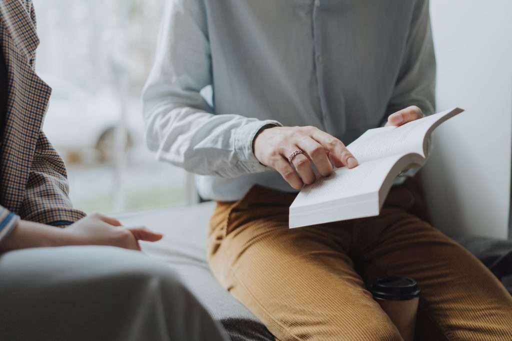 Person reading with another to increase knowledge and cope with mental distress